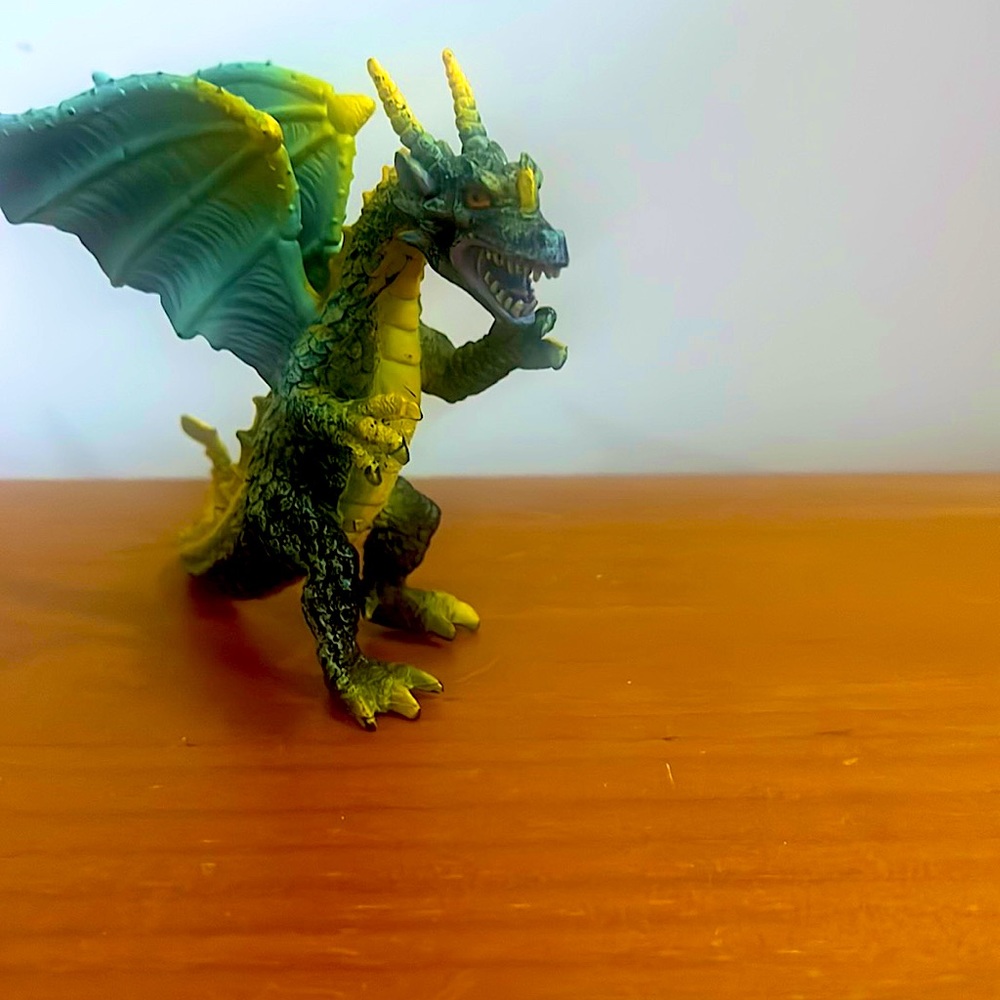 Green,black , and yellow mystical dragon figure